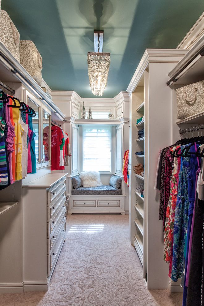 This is an example of a traditional women's dressing room in Detroit with open cabinets, white cabinets and carpet.