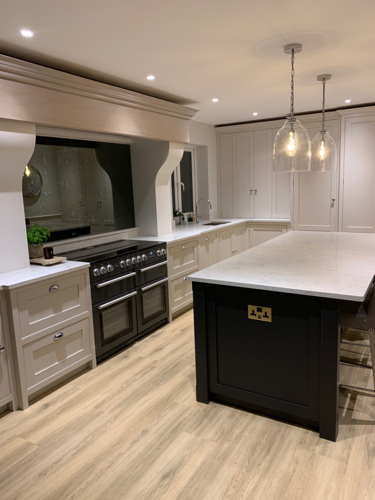 Inspiration for a mid-sized contemporary l-shaped kitchen in Surrey with beaded inset cabinets, quartzite benchtops, mirror splashback, with island and white benchtop.