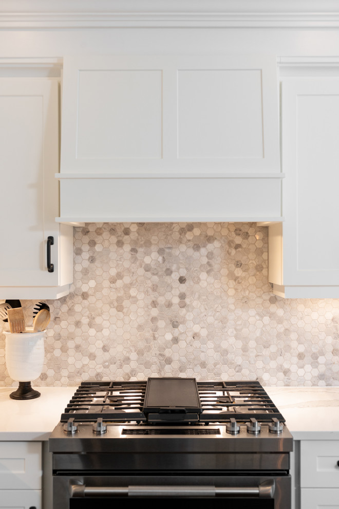 Inspiration for a transitional dark wood floor and brown floor kitchen remodel with white cabinets, quartz countertops, paneled appliances, an island and white countertops