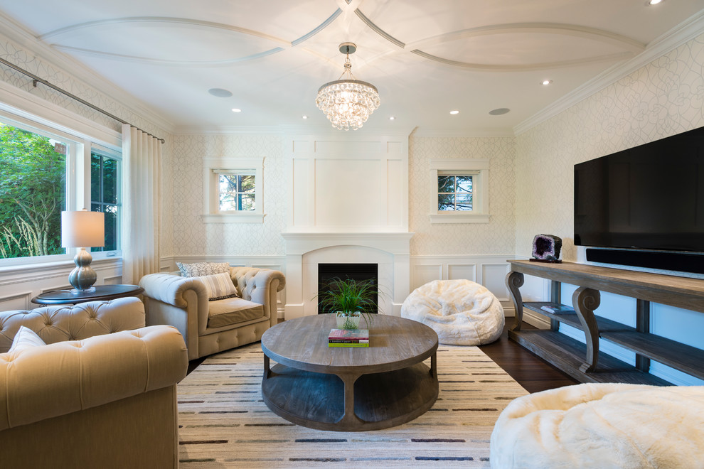 This is an example of a large transitional open concept family room in Vancouver with white walls, dark hardwood floors, a wall-mounted tv, a standard fireplace and a plaster fireplace surround.