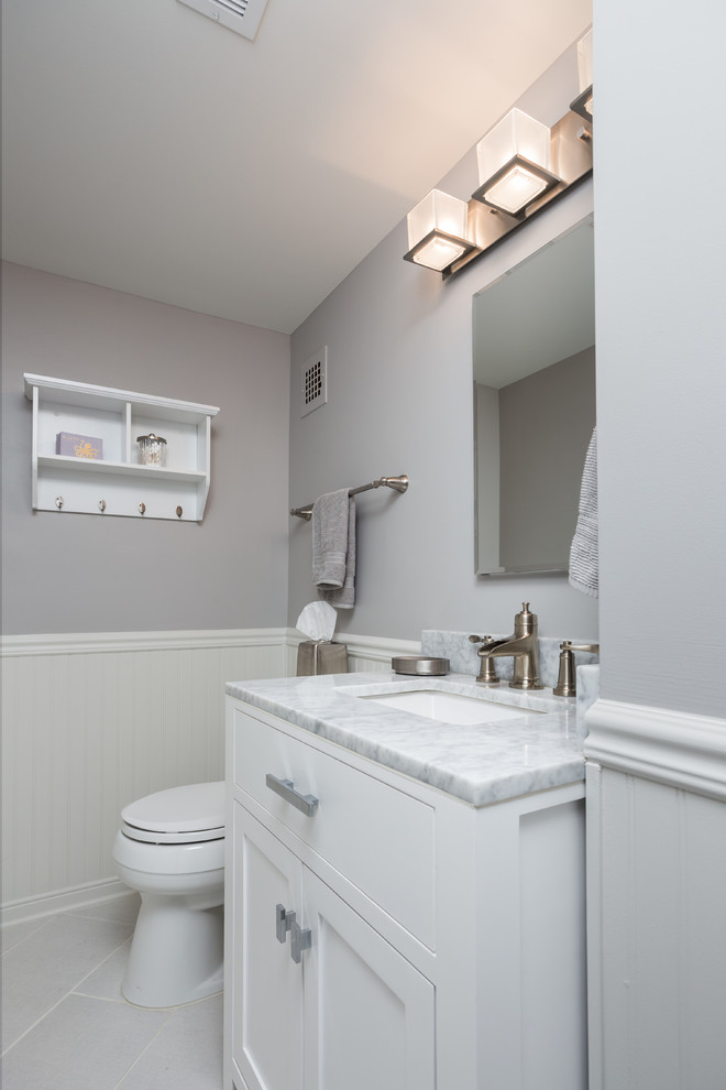 Mid-sized transitional 3/4 porcelain tile and gray floor bathroom photo in DC Metro with shaker cabinets, white cabinets, a two-piece toilet, gray walls, an undermount sink, marble countertops and gray countertops
