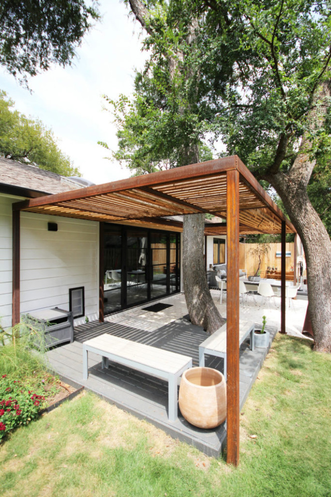 Design ideas for a medium sized modern back ground level metal railing terrace in Dallas with a pergola.