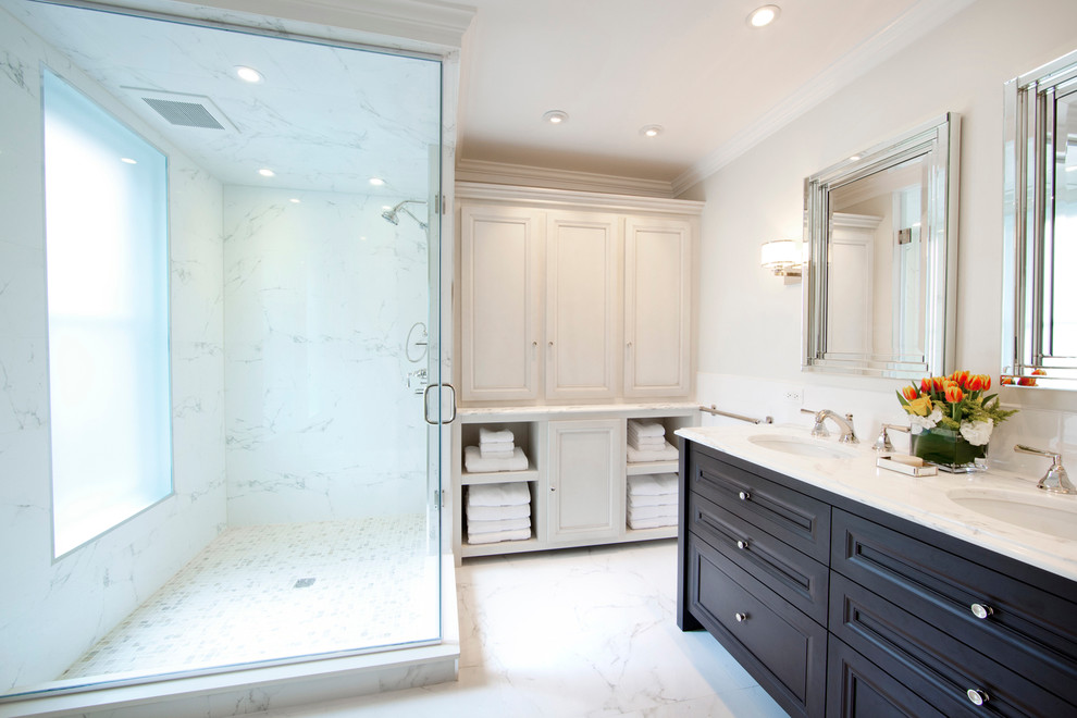 Mid-sized traditional master bathroom in Philadelphia with an undermount sink, dark wood cabinets, a corner shower, a two-piece toilet, white tile, ceramic tile, white walls, marble floors, marble benchtops, white floor, a hinged shower door and recessed-panel cabinets.
