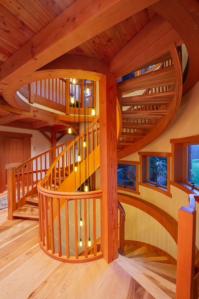 Inspiration for a large eclectic wood spiral staircase in New York with wood risers and wood railing.