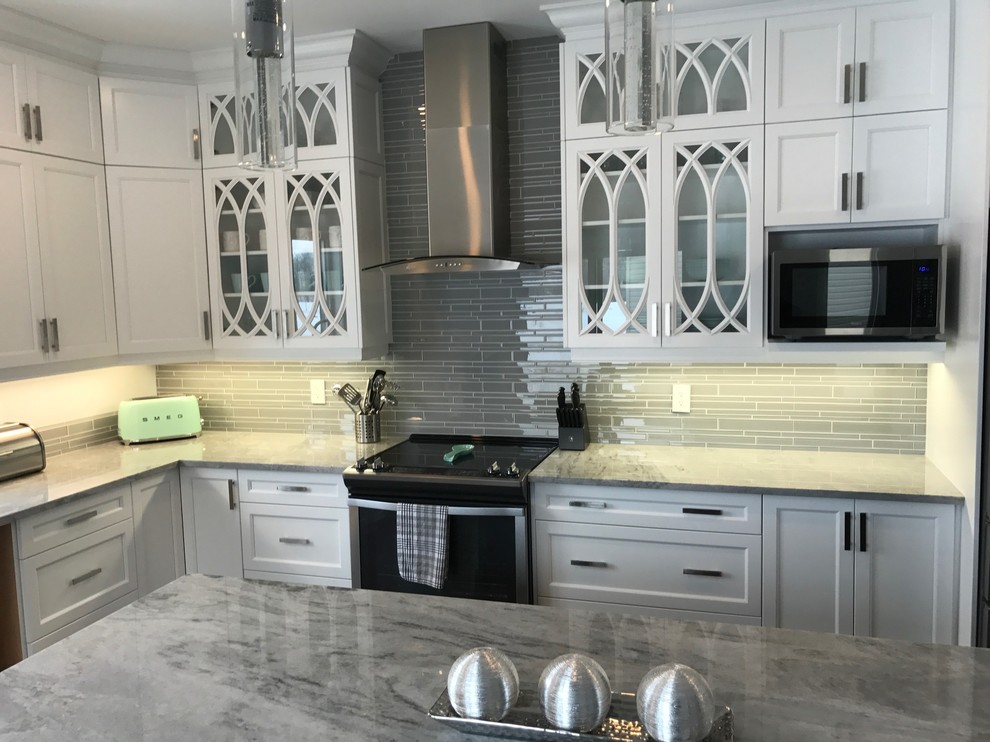 Kitchen - mid-sized transitional l-shaped medium tone wood floor and brown floor kitchen idea in Ottawa with an undermount sink, shaker cabinets, white cabinets, quartz countertops, gray backsplash, matchstick tile backsplash, stainless steel appliances and an island