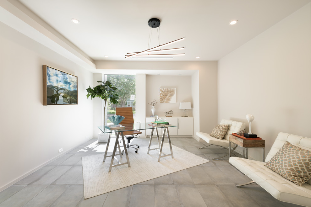 Trendy freestanding desk concrete floor and gray floor study room photo in Houston with white walls