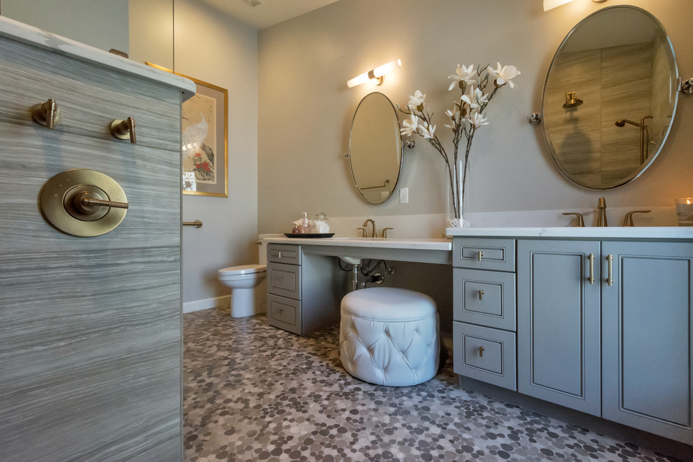 Design ideas for a mid-sized transitional master bathroom in Phoenix with raised-panel cabinets, grey cabinets, an open shower, a one-piece toilet, gray tile, porcelain tile, grey walls, pebble tile floors, a drop-in sink, quartzite benchtops, grey floor and an open shower.