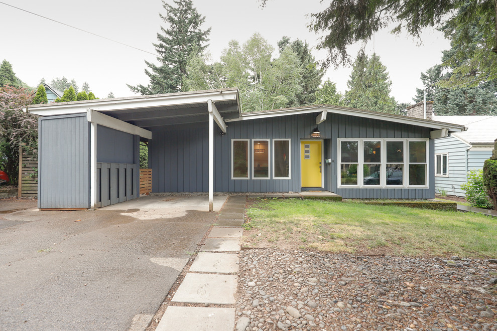 This is an example of a mid-sized midcentury one-storey blue house exterior in Portland with wood siding and a shingle roof.