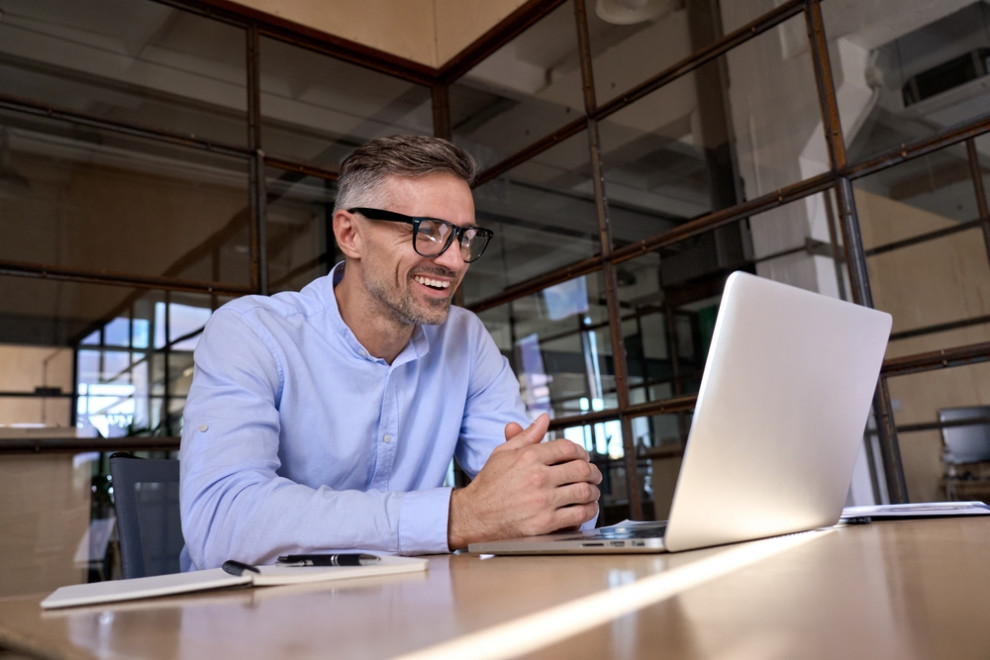 man on video call on laptop