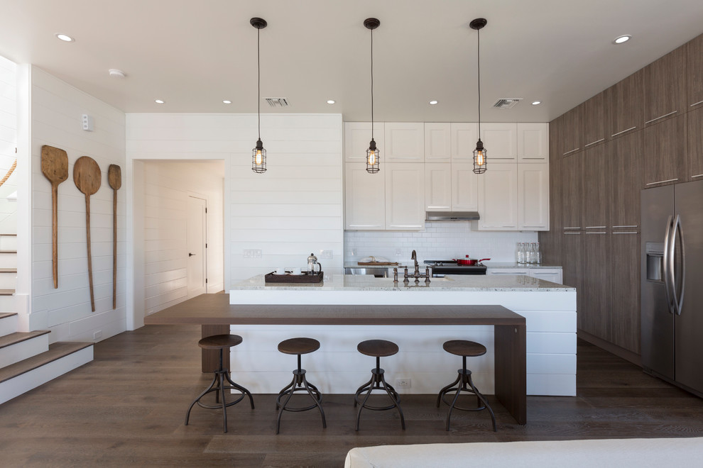 Inspiration for a large transitional l-shaped dark wood floor open concept kitchen remodel in Miami with an undermount sink, shaker cabinets, light wood cabinets, granite countertops, white backsplash, mosaic tile backsplash, stainless steel appliances and an island