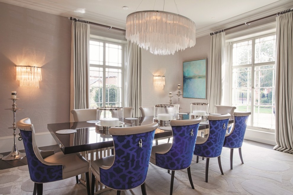 This is an example of a transitional dining room in London with beige walls.