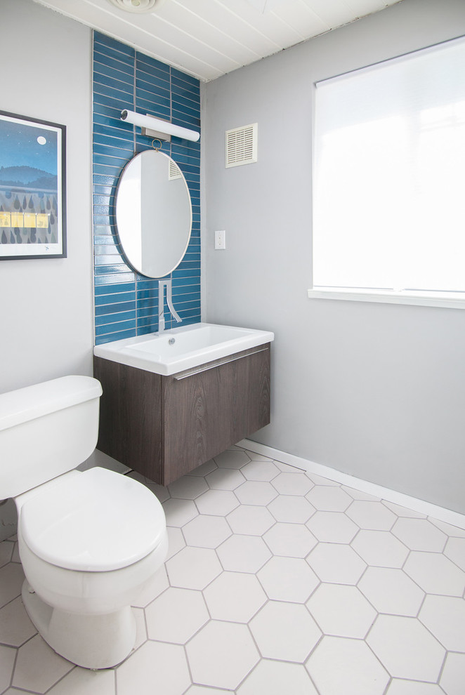 Photo of a midcentury kids bathroom in San Francisco with flat-panel cabinets, medium wood cabinets, blue tile, ceramic tile, grey walls and ceramic floors.