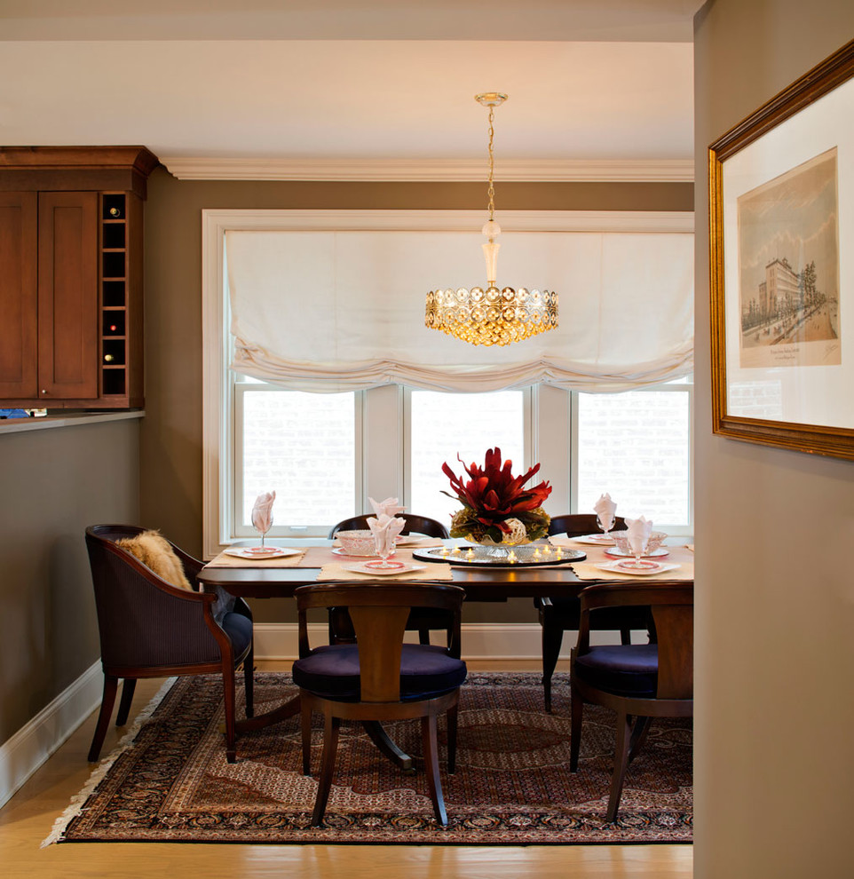 Photo of a large transitional kitchen/dining combo in Chicago with brown walls and medium hardwood floors.