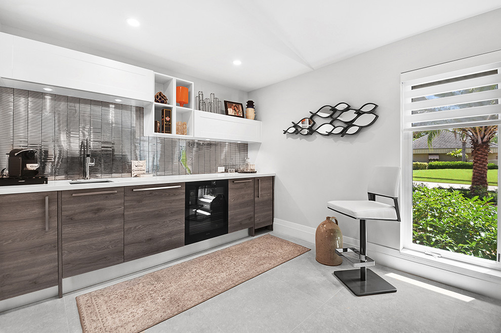 Design ideas for a mid-sized modern single-wall wet bar in Miami with a drop-in sink, medium wood cabinets, quartz benchtops, metal splashback, porcelain floors, grey floor and white benchtop.