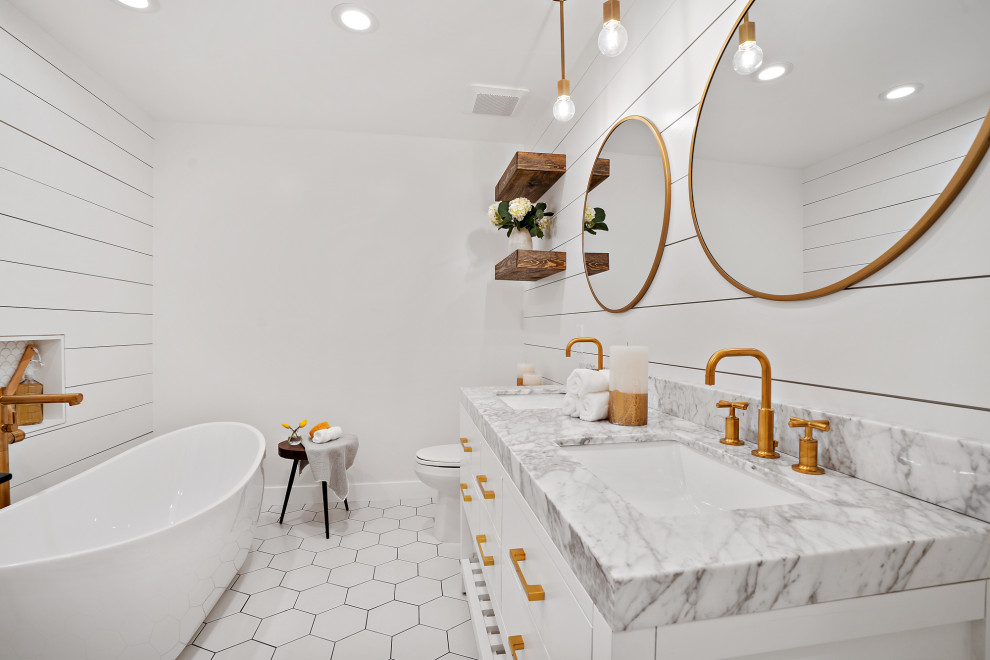 This is an example of a large transitional master bathroom in San Francisco with white cabinets, a freestanding tub, white walls, porcelain floors, an undermount sink, white floor, grey benchtops, a niche, a double vanity, a built-in vanity, planked wall panelling and flat-panel cabinets.