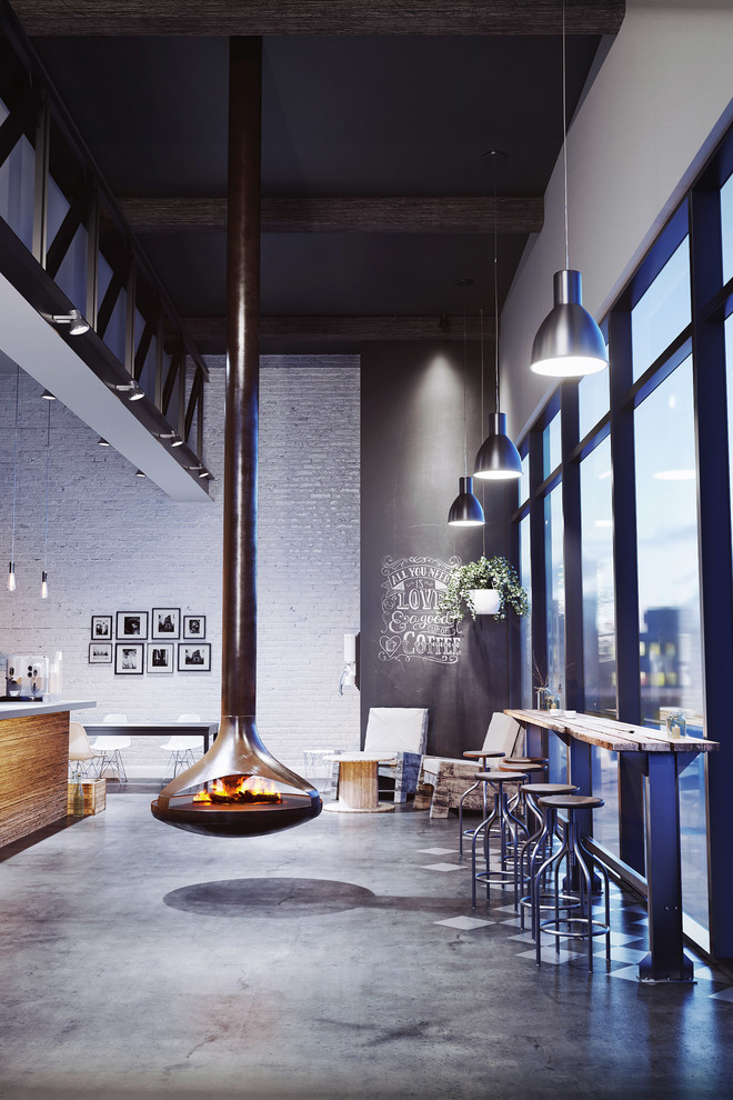 Photo of an industrial family room in Toronto with a hanging fireplace.