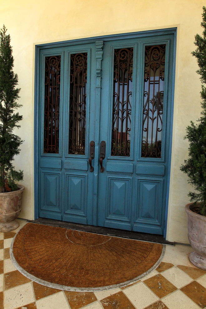 Large mediterranean front door in Los Angeles with beige walls, a double front door, a blue front door, marble floors and multi-coloured floor.