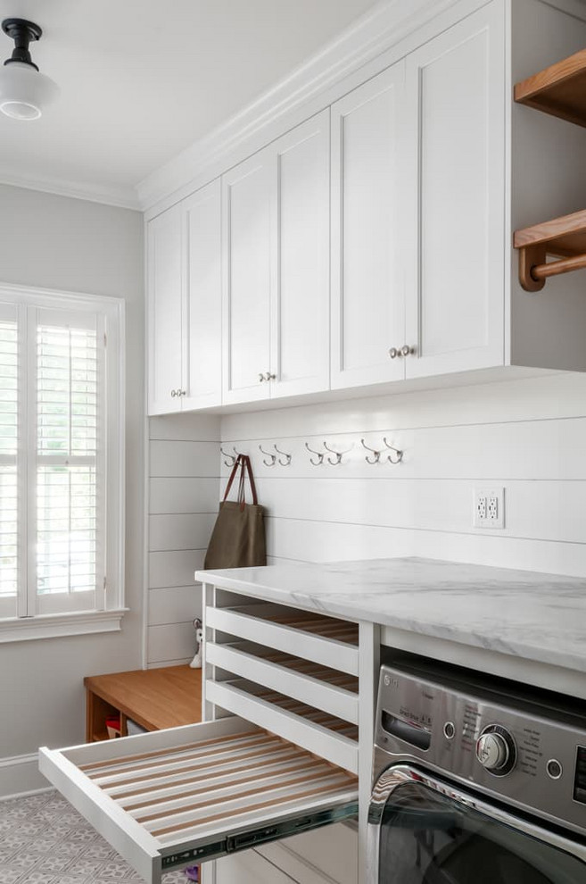 Inspiration for a mid-sized traditional utility room in Atlanta with shaker cabinets, white cabinets, marble benchtops, ceramic floors, white benchtop, white walls, multi-coloured floor and planked wall panelling.