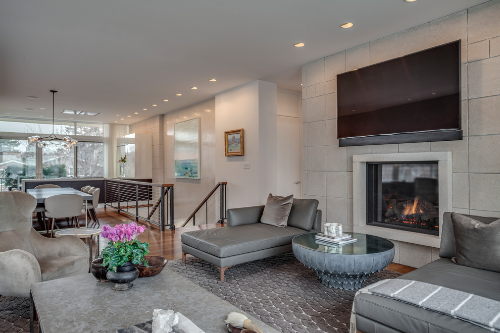 Photo of a contemporary open concept living room in Minneapolis with beige walls, carpet, a ribbon fireplace, a stone fireplace surround, a wall-mounted tv and brown floor.