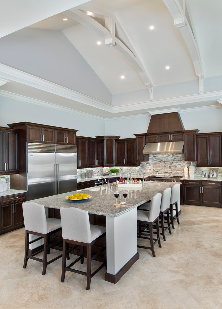 Traditional l-shaped kitchen in Miami with an undermount sink, recessed-panel cabinets, dark wood cabinets, multi-coloured splashback, stainless steel appliances and with island.
