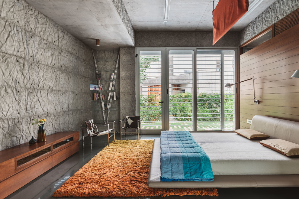 This is an example of a modern bedroom in Other with grey walls and grey floor.