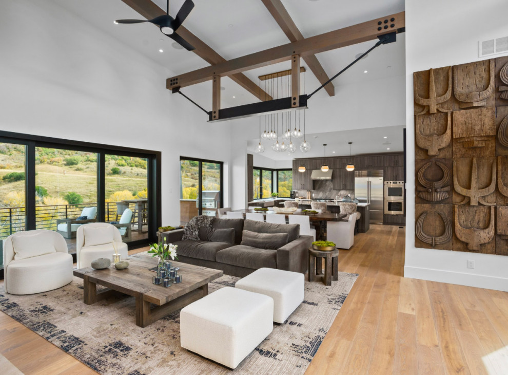 Photo of a contemporary formal open concept living room in Denver with white walls, light hardwood floors and vaulted.