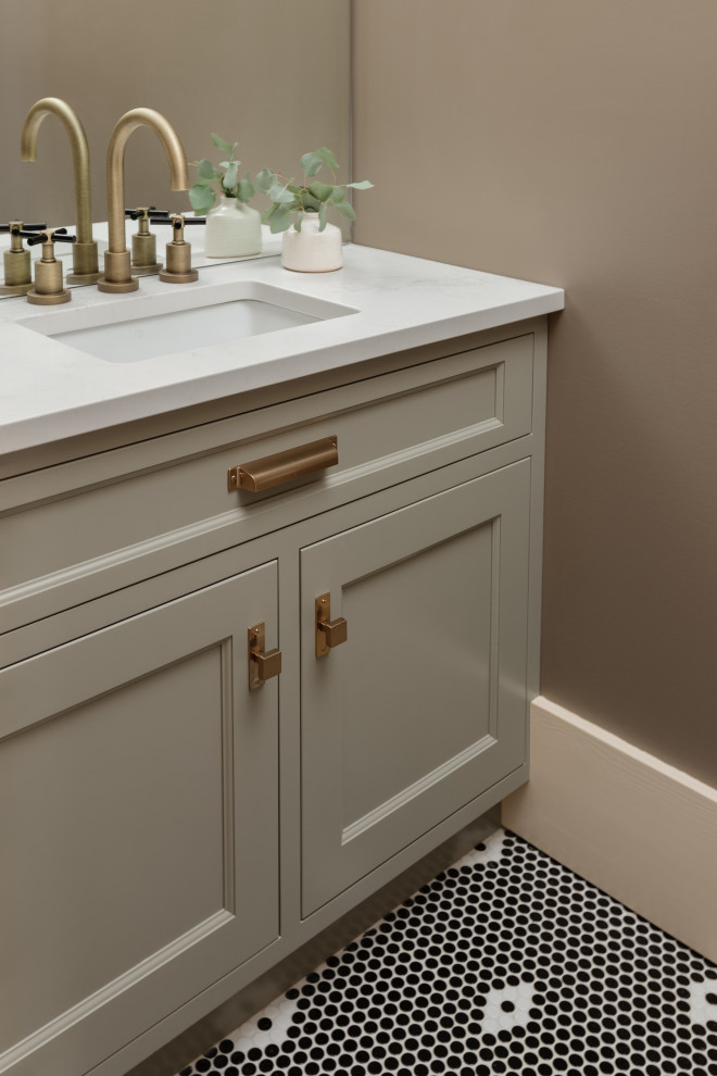 Inredning av ett amerikanskt litet vit vitt toalett, med grå skåp, bruna väggar, mosaikgolv, ett undermonterad handfat, bänkskiva i kvarts och svart golv
