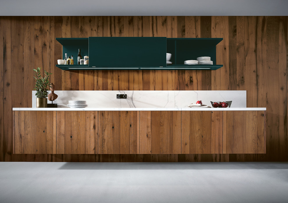 Design ideas for an open plan kitchen in Nuremberg with flat-panel cabinets, medium wood cabinets, timber splashback and white benchtop.