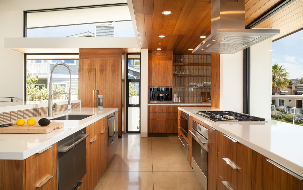 Photo of a large contemporary single-wall open plan kitchen in Orange County with an undermount sink, flat-panel cabinets, medium wood cabinets, brown splashback, with island, quartz benchtops, stainless steel appliances, linoleum floors and grey floor.