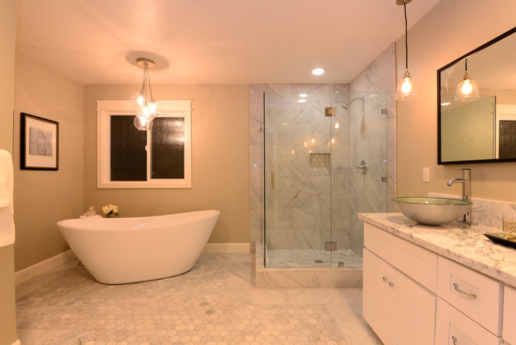 Inspiration for a large traditional master bathroom in Orange County with shaker cabinets, white cabinets, a freestanding tub, a corner shower, gray tile, white tile, stone tile, beige walls, mosaic tile floors, a vessel sink, white floor and a hinged shower door.