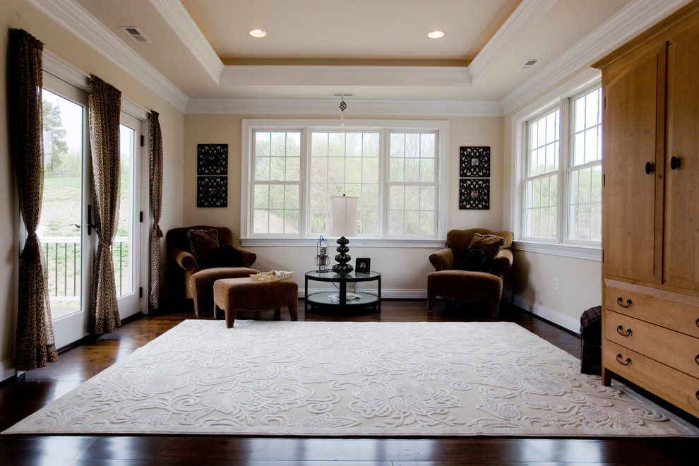 Inspiration for an expansive traditional master bedroom in Baltimore with beige walls, dark hardwood floors, a standard fireplace, a tile fireplace surround and brown floor.