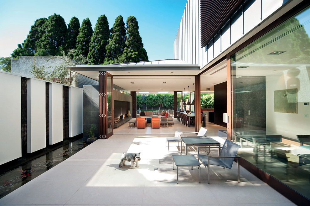 This is an example of a contemporary courtyard patio in Melbourne with a water feature and no cover.