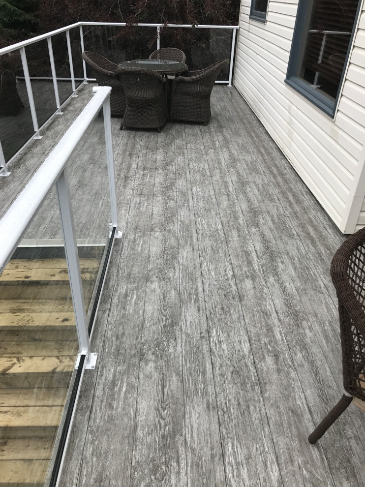 Inspiration for a mid-sized rustic backyard deck remodel in Calgary with no cover