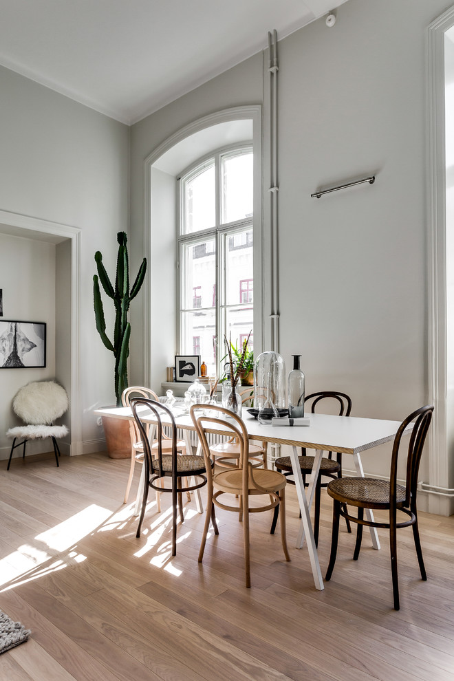 Inspiration for a large scandinavian open plan dining in Stockholm with grey walls and medium hardwood floors.