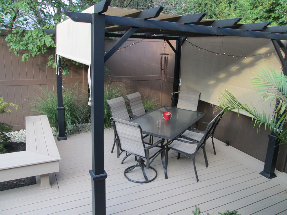 Deck - mid-sized transitional backyard deck idea with a pergola