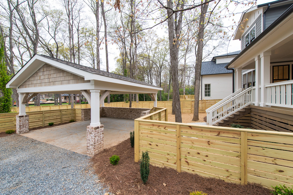 This is an example of a mid-sized arts and crafts detached two-car carport in Charlotte.