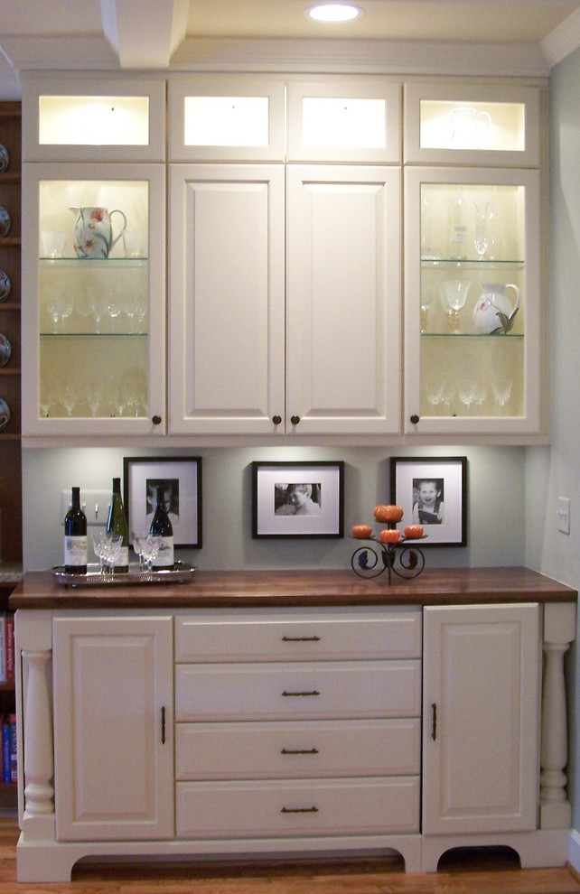 Mid-sized transitional single-wall wet bar in DC Metro with no sink, raised-panel cabinets, white cabinets, wood benchtops and dark hardwood floors.