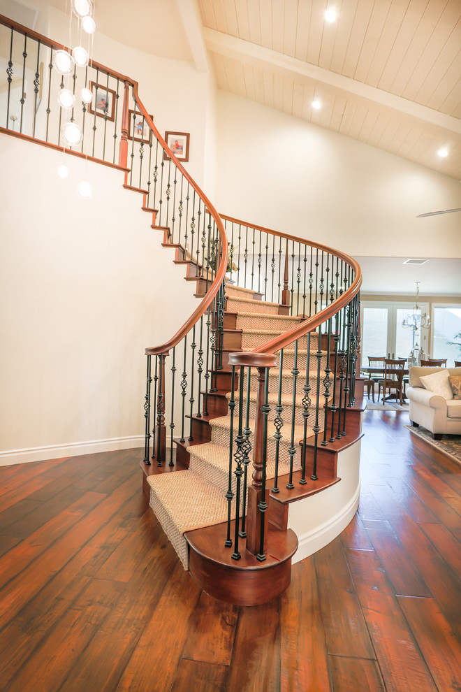 Inspiration for a beach style wood curved staircase in San Diego with wood risers.