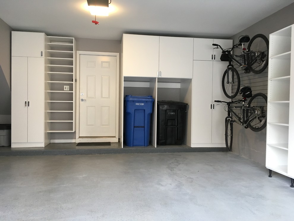 This is an example of a mid-sized contemporary attached two-car garage in Chicago.