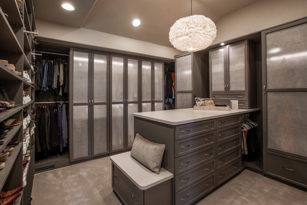 Inspiration for a mid-sized transitional gender-neutral walk-in wardrobe in Denver with open cabinets, grey cabinets, carpet and grey floor.