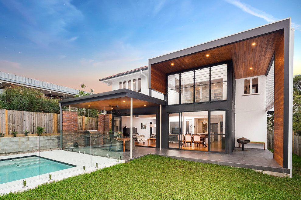 Inspiration for a large modern house exterior in Brisbane with wood siding and a tile roof.