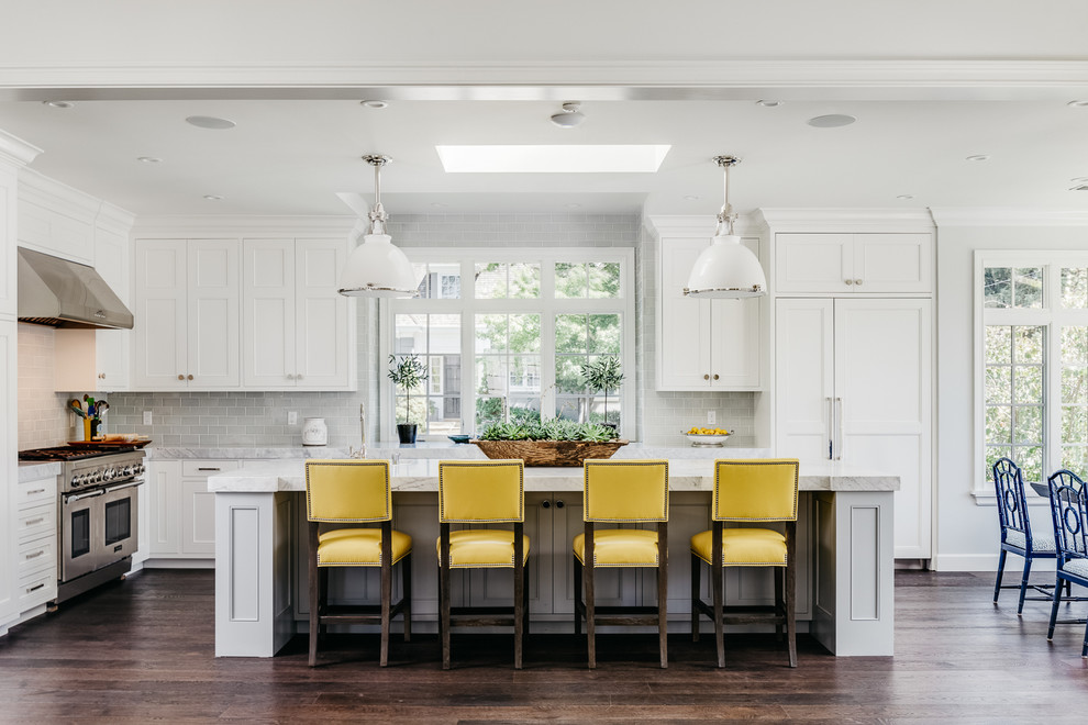 Large transitional l-shaped kitchen in San Francisco with recessed-panel cabinets, white cabinets, grey splashback, subway tile splashback, stainless steel appliances, dark hardwood floors and with island.