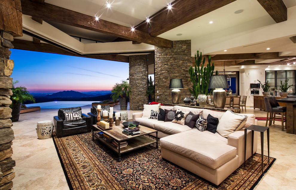 This is an example of an open concept living room in Phoenix with beige floor.