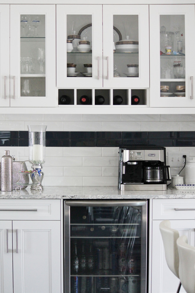 Inspiration for a large transitional u-shaped eat-in kitchen remodel with shaker cabinets, white cabinets, quartz countertops, white backsplash, subway tile backsplash, gray countertops, stainless steel appliances and an island