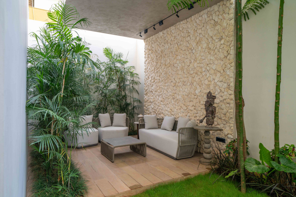 Photo of a contemporary patio With Tile and a Roof Extension.
