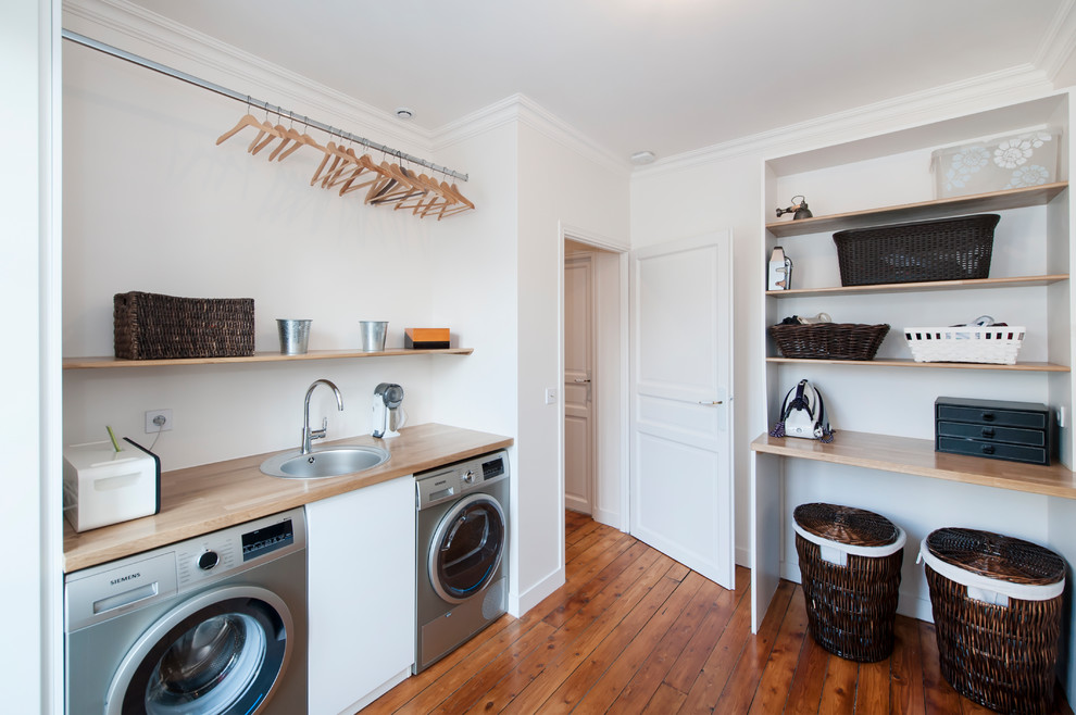 Transitional laundry room in Paris.