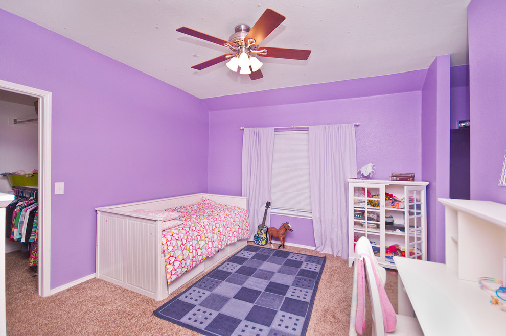 Photo of a traditional kids' bedroom for girls in Dallas with purple walls and carpet.