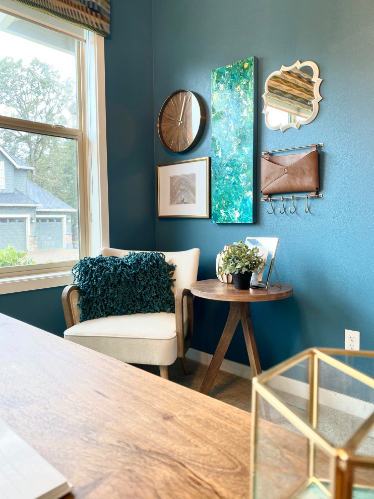 Design ideas for a mid-sized transitional home office in Portland with blue walls, carpet, a freestanding desk, beige floor and wallpaper.