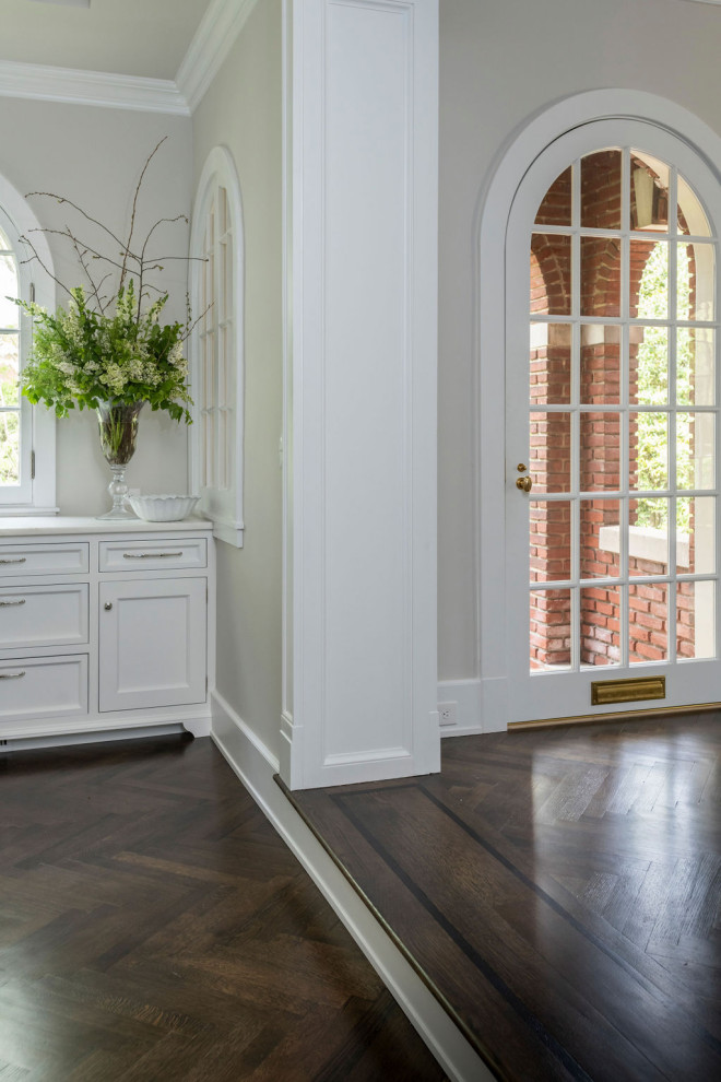 This is an example of a classic hallway in Baltimore with grey walls, dark hardwood flooring and brown floors.