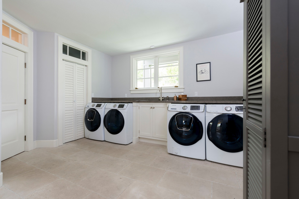 Inspiration for a large transitional single-wall dedicated laundry room in Los Angeles with an undermount sink, beaded inset cabinets, beige cabinets, limestone benchtops, blue walls, limestone floors, a side-by-side washer and dryer and beige floor.